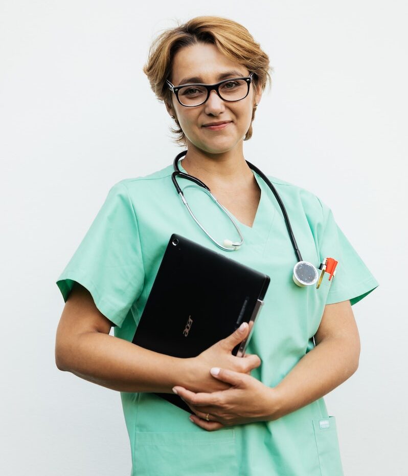 A Woman wearing Eyeglasses While Holding Laptop
